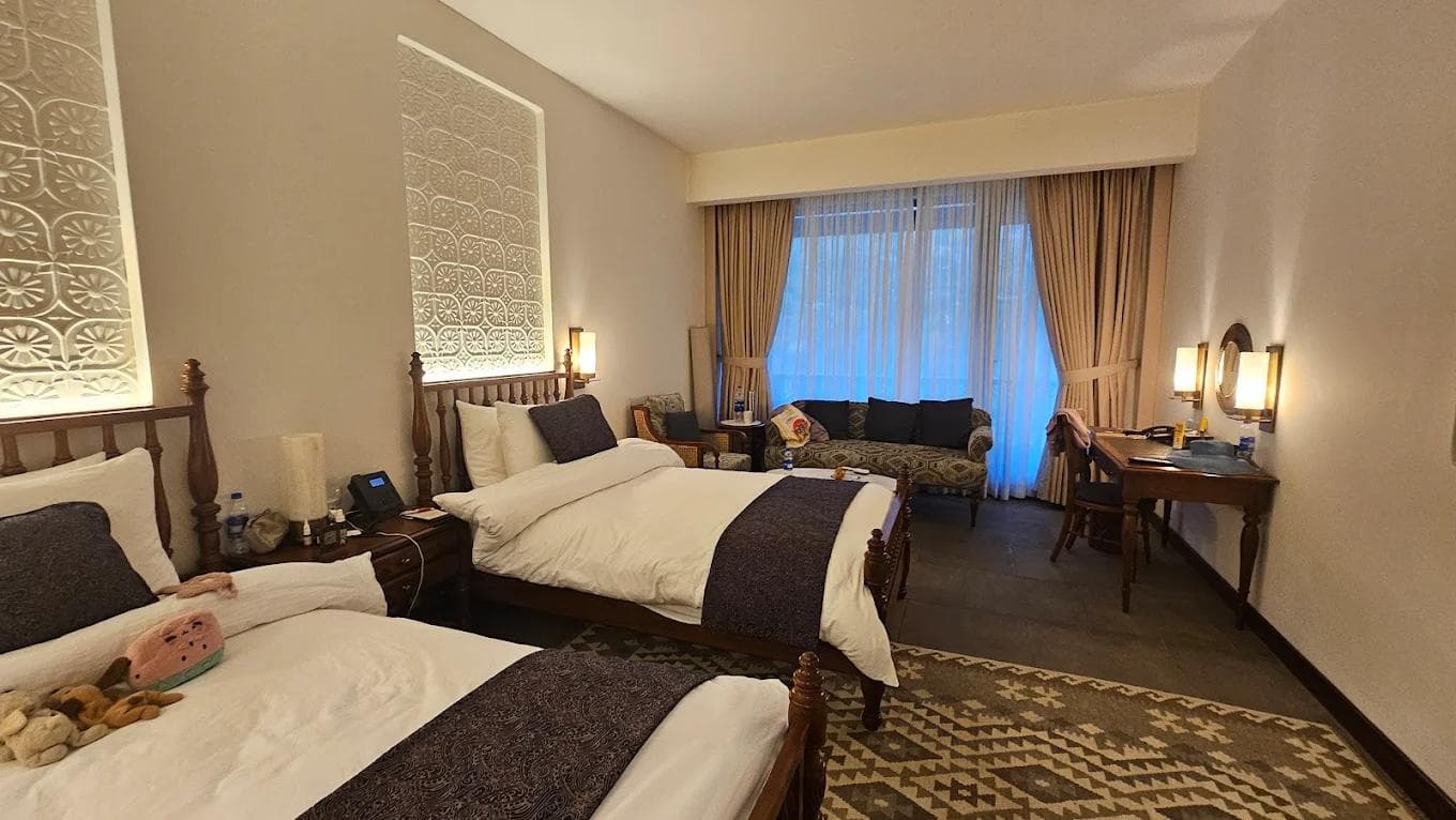 Hunza Serena Hotel facade in Karimabad with Ultar Sar mountain in the background and traditional stone architecture