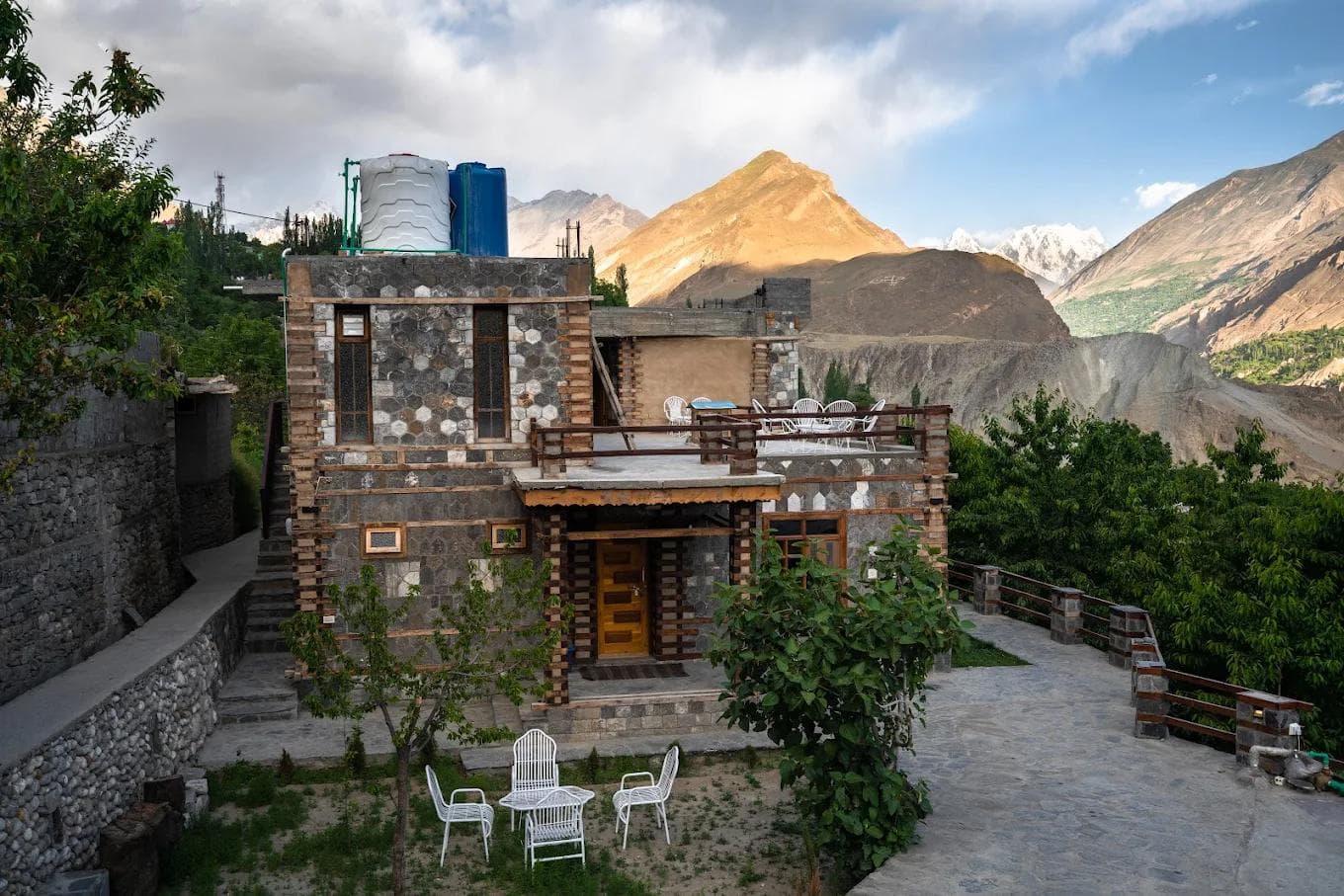 Off Grid Home Hunza traditional stone guesthouse in Ganish village with Rakaposhi and Diran peaks visible from the terrace